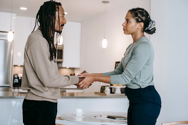 Two people holding hands and looking at eachother